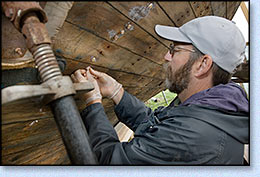 John Staunton gluing a bung in place